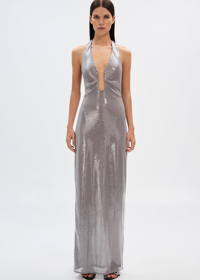 Woman wearing a silver metallic dress on a white background