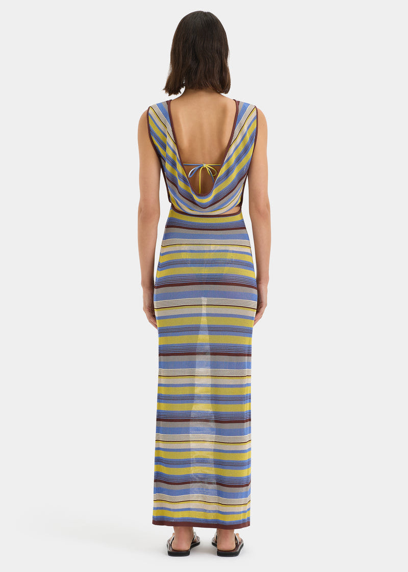 Woman wearing a striped dress with a white background