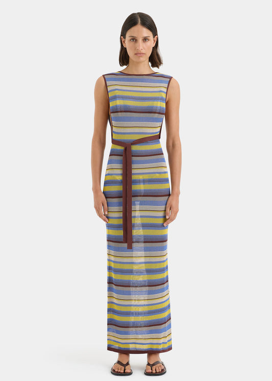 Woman wearing a striped dress with a belt on a white background