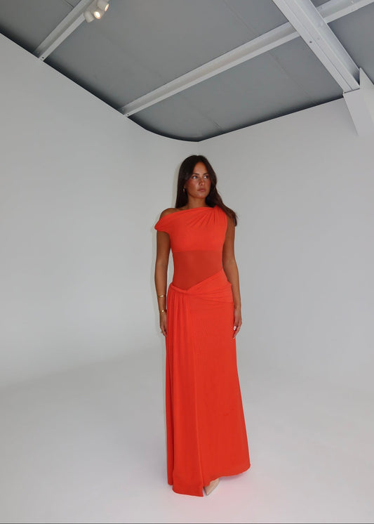 Woman wearing a red evening gown on a white background